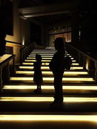 Rear view of women walking on steps