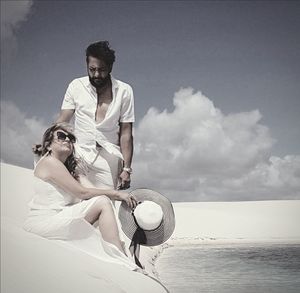 Young couple on beach against sky