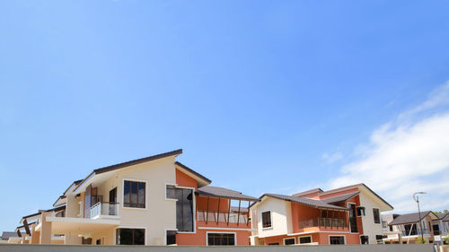 Low angle view of buildings against blue sky