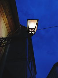 Low angle view of illuminated street light against sky at night