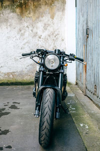 Black motorcycle parked on street in city