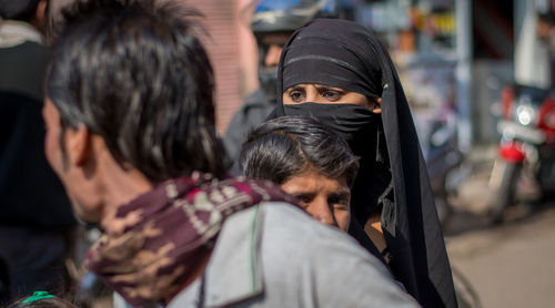 Rear view of people on street in city