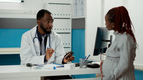 Female doctor examining x-ray at clinic