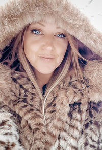 Portrait of smiling woman in snow