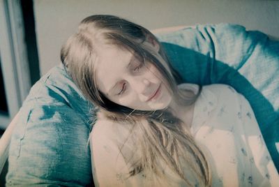 Portrait of woman relaxing on bed at home