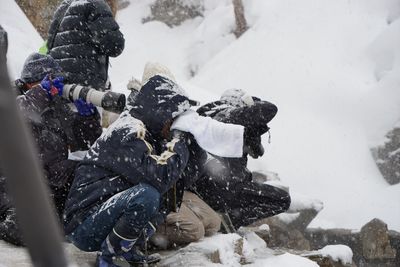 Rear view of person in snow on field