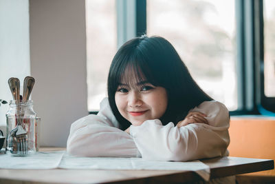 Portrait of smiling girl sitting at restaurant