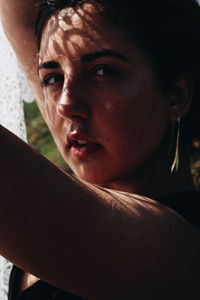 Young woman with white scarf on field during sunny day