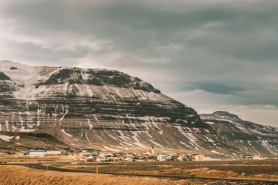 Scenic view of land and mountains against sky