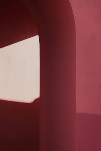 Sunlight falling on red wall
