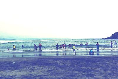 Rear view of people on beach