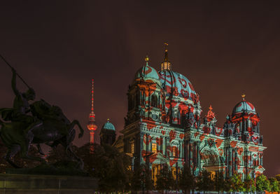 Low angle view of illuminated cathedral against sky at night