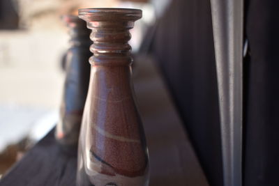 Close-up of old bottle on wall