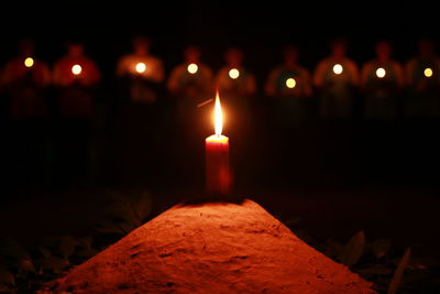 Close-up of lit candles in the dark