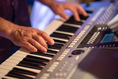 Midsection of man playing piano