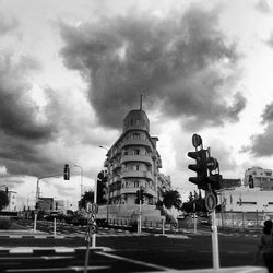 Buildings against cloudy sky