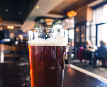 Close-up of beer glass on table