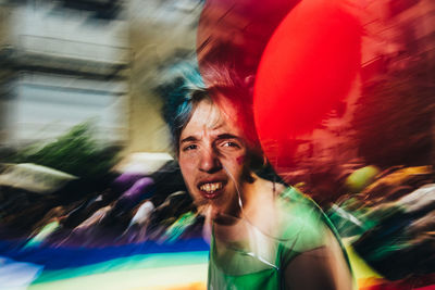 Portrait of woman with multi colored umbrella