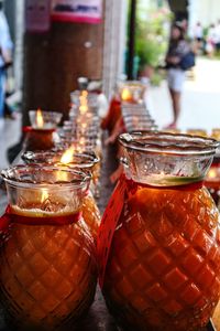 Close-up of lit candles on table