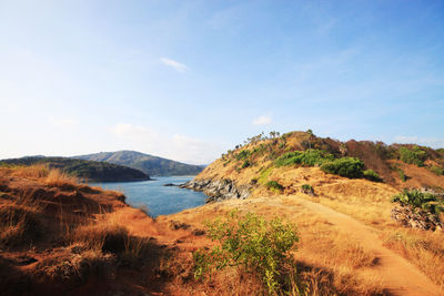 Scenic view of sea and mountains against sky