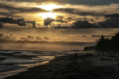 Scenic view of beach against sky during sunset