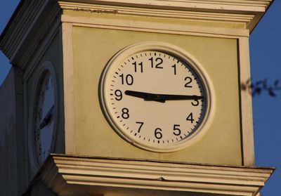 Low angle view of clock on wall