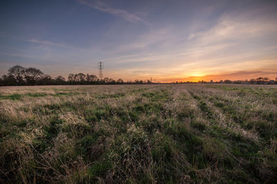 Scenic view of field against sky during sunset