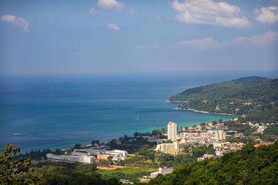 High angle view of buildings and sea against sky