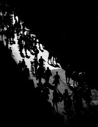 High angle view of silhouette people walking on street at night