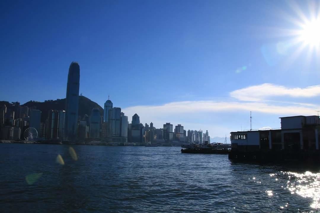 SUNSET OVER RIVER WITH BUILDINGS IN BACKGROUND