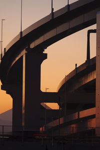 Low angle view of bridge against sky during sunset