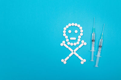 High angle view of clock on blue background