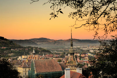 View of buildings in city at sunset