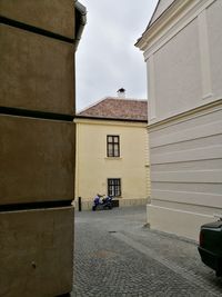 Street amidst buildings in city against sky