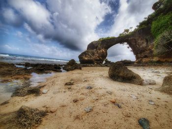 Rocks on beach against sky