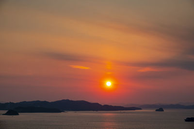 Scenic view of sea against romantic sky at sunset