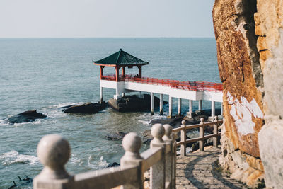 Lifeguard hut on sea shore against clear sky