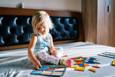 Portrait of cute girl drawing on bed at home