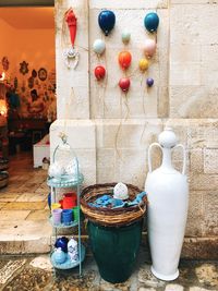 Close-up of multi colored bottles hanging on wall