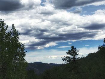 Scenic view of mountains against cloudy sky