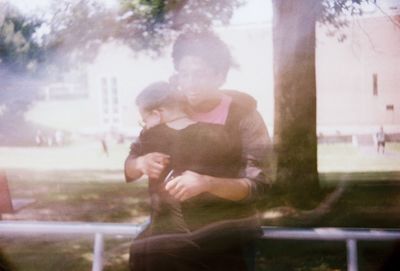 Rear view of mother and daughter outdoors