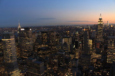 Aerial view of city lit up at night