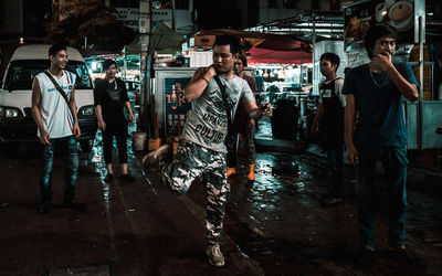 People walking on street in city at night