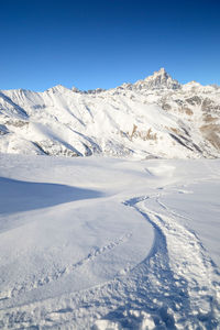 Scenic view of snowcapped mountains against sky