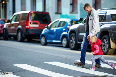 Full length of man standing on road in city