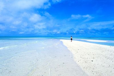 Scenic view of beach against blue sky