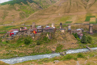 High angle view of houses amidst trees and buildings