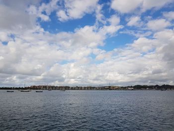Scenic view of sea and buildings against sky