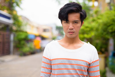 Portrait of young man standing outdoors