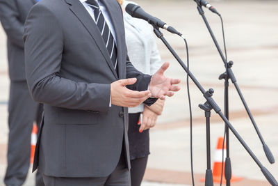 Midsection of speaker giving speech